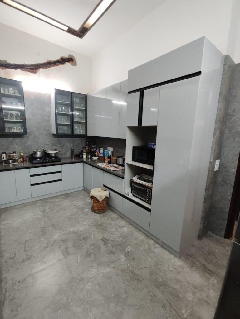 Grey modular kitchen with tall appliance unit