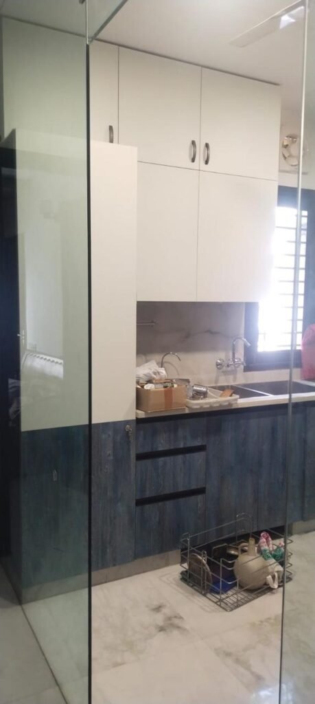 White and blue modular kitchen with tall storage
