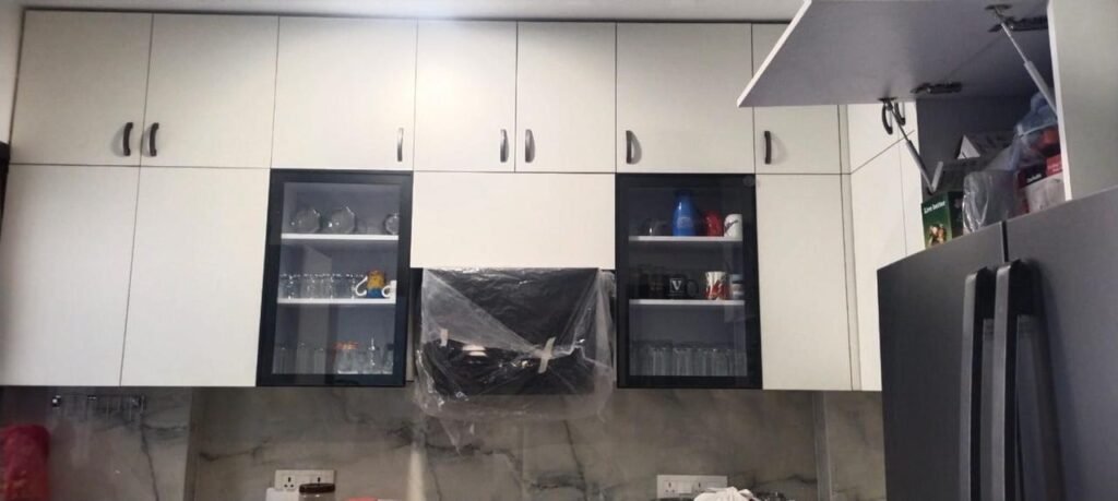 White kitchen wall units with glass shutters