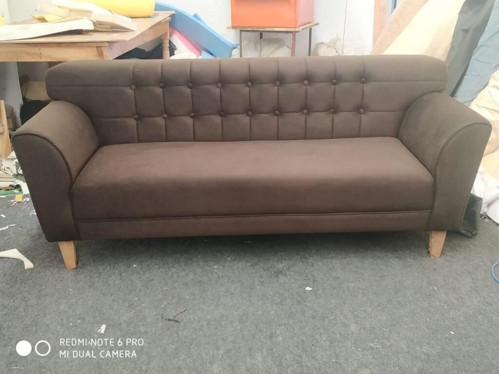 Brown three-seater sofa upholstered in our workshop